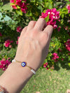 circle glass evil eye bracelet on wrist