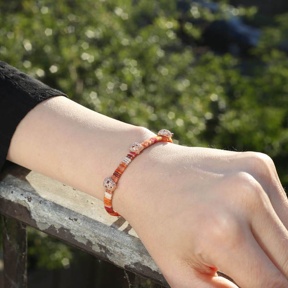 skulls-on-orange-cotton-silver-wave-bracelet-1